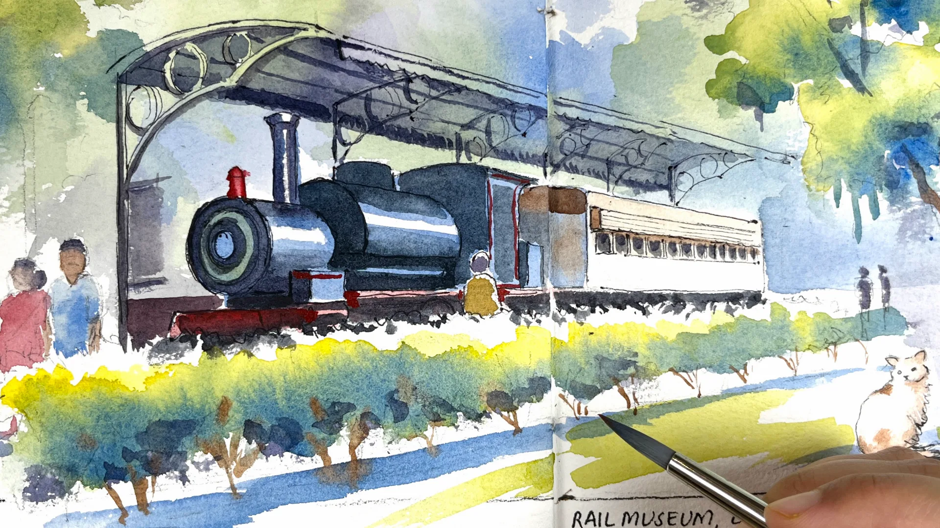 Journal page of a steam locomotive under the canopy at a rail museum, with visitors and trees