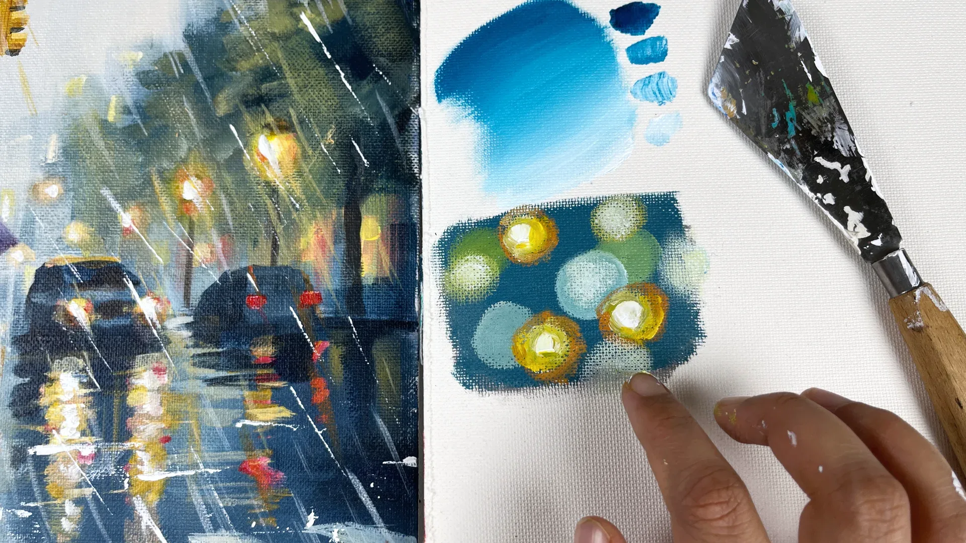 Finished monsoon street acrylic beside a painted colour study and palette knife